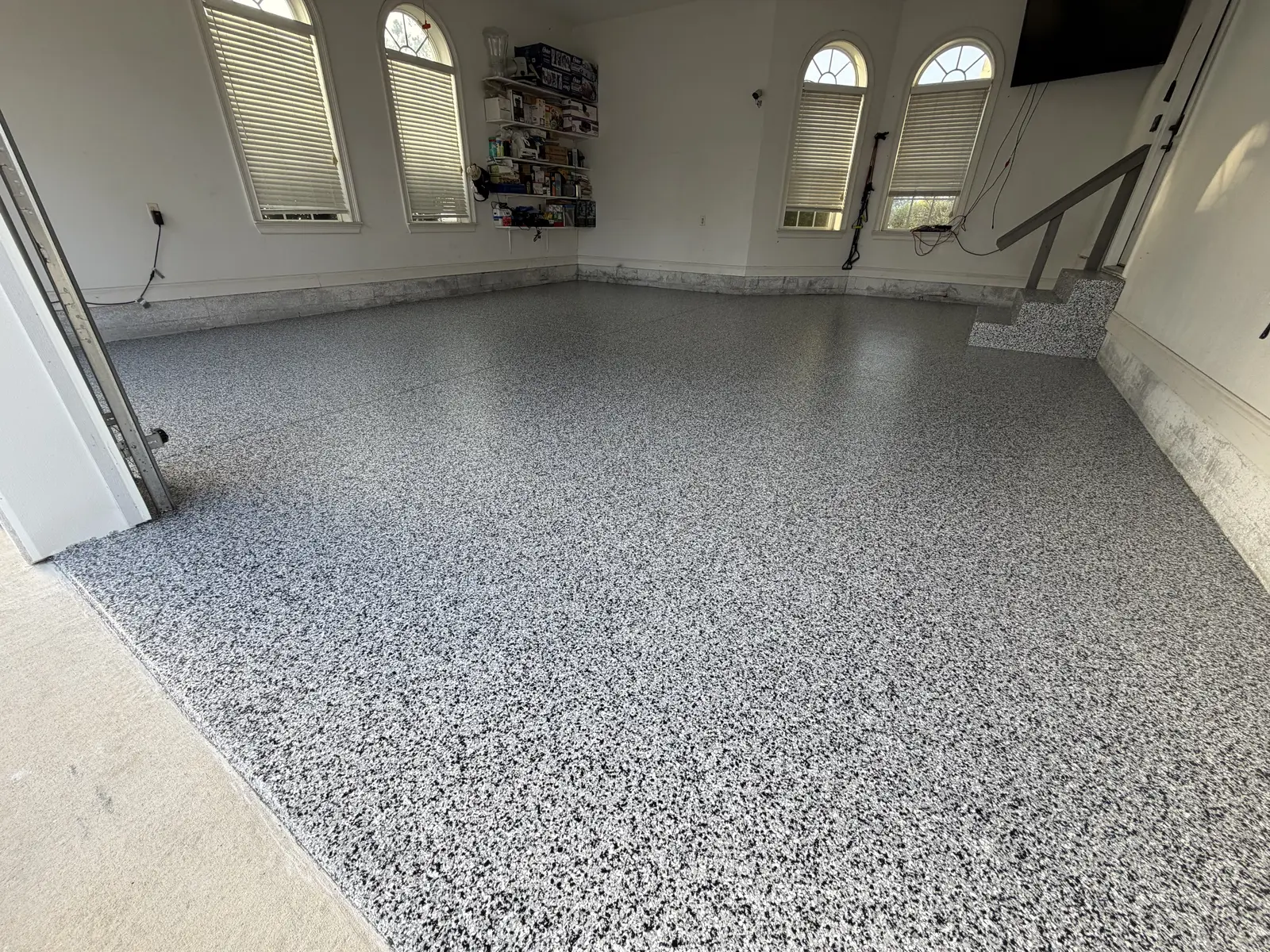 Flake garage floor coating in a garage with arched windows