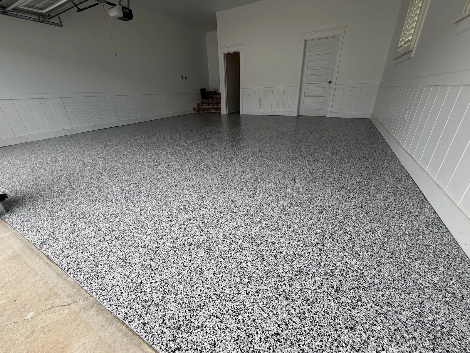 Flake garage floor coating in a garage with white walls