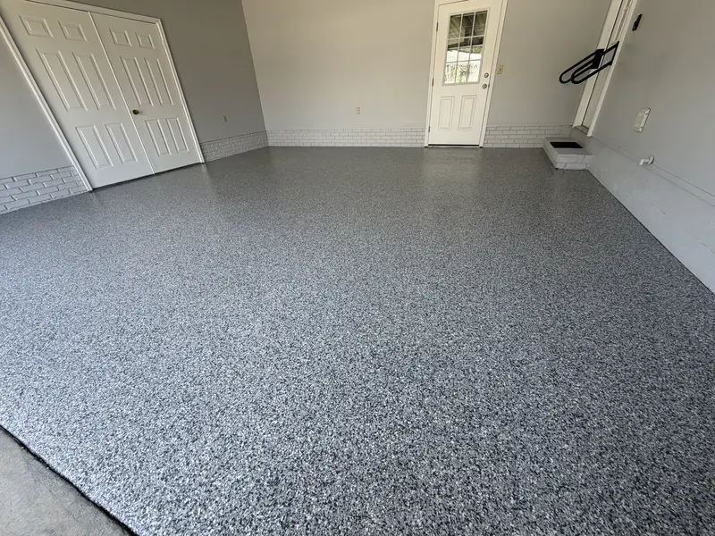 Gray flake floor coating in an empty two-car garage